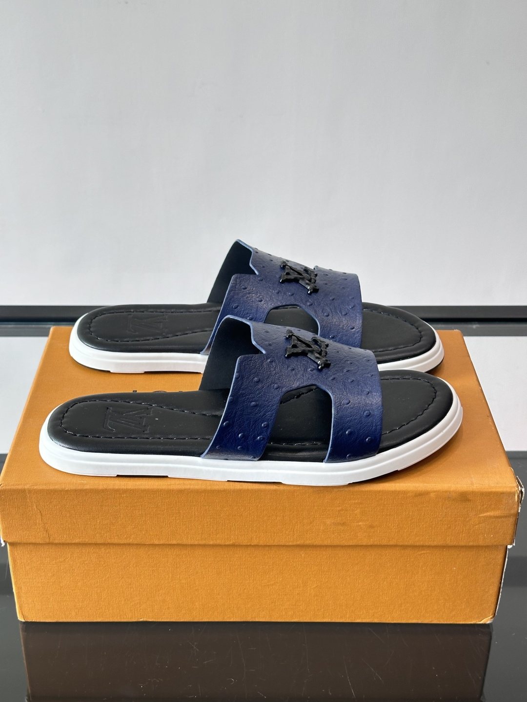 Louis Vuitton Embossed Blue Slide Sandals — front